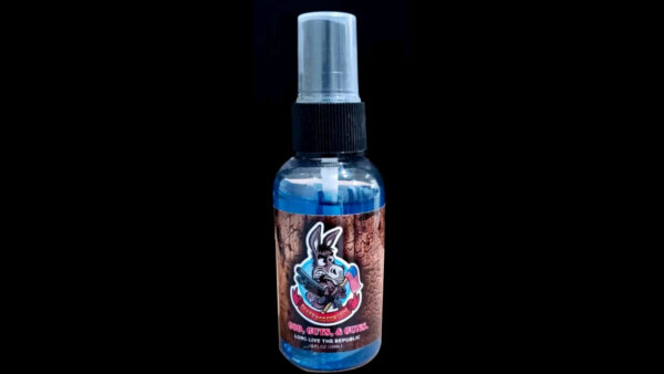 A spray bottle with blue liquid on it.
