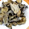 A white plate topped with lots of dried leaves.