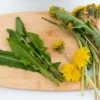 A cutting board with some dandelions on it